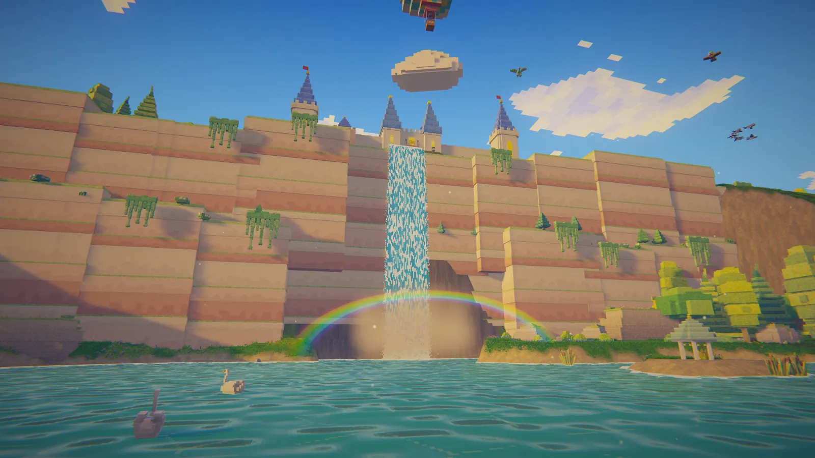 Scène de jeu en voxels créée avec BlockImagine : Une cascade avec un arc-en-ciel au pied des falaises